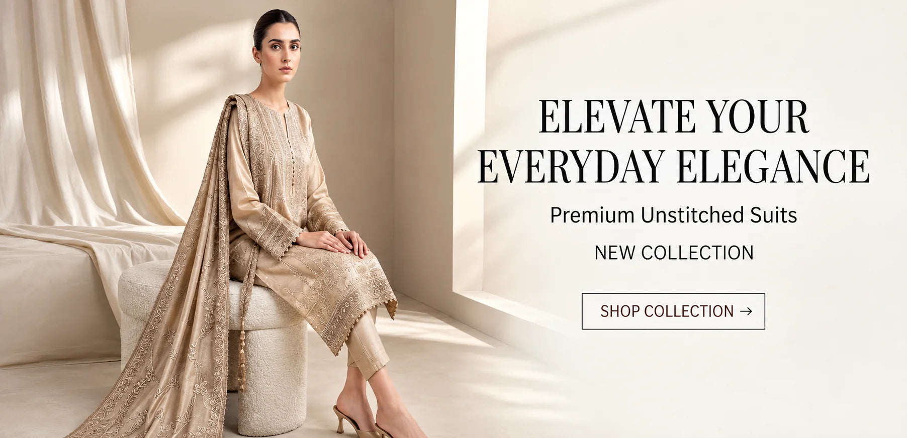 A woman models a traditional unstitched suit set in a warm beige tone, sitting on a white stool in a softly lit interior. Text on the right reads 'ELEVATE YOUR EVERYDAY ELEGANCE Premium Unstitched Suits NEW COLLECTION' with a 'SHOP COLLECTION ->' button.
